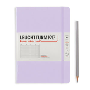 Purple notebook with Leuchtturm1917 branding and a pencil on a white background