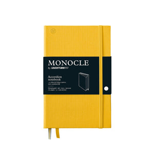 Yellow Monocle Wallet notebook with Monocle branding on a white background