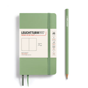 Green notebook and pencil with Leuchtturm1917 branding on a white background