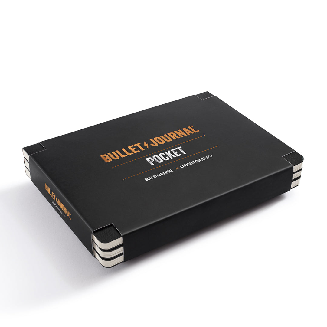 Black notebook with 'Bullet Journal' branding on a white background