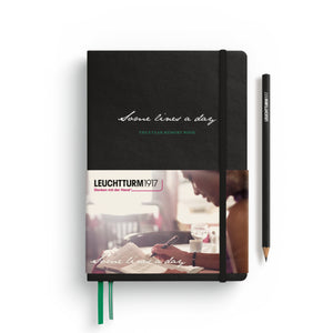 Black notebook with label featuring Leuchtturm1917 branding, and a pencil on a white background.