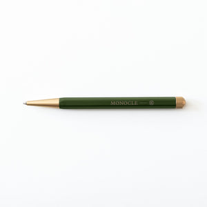 Green pen with gold accents on a white background