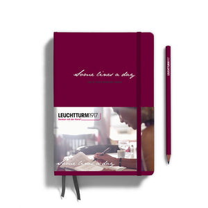 Maroon notebook with 'Leuchtturm1917' branding and a pencil on a white background