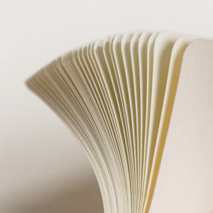 Close-up of flipping through notebook pages with a soft focus background