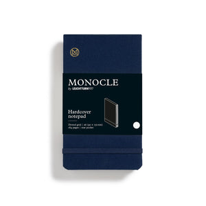 Navy blue notebook with Monocle branding on a white background
