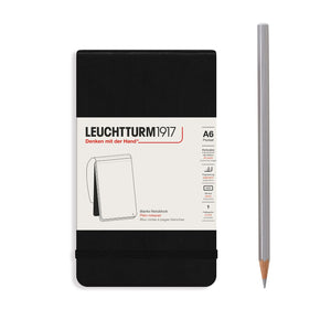 Leuchtturm1917 notebook with a black cover and a silver pencil on a white background