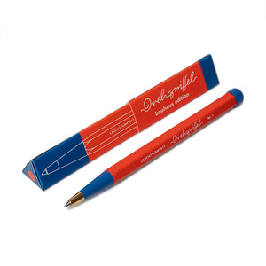 Red pen with blue accents and packaging on a white background
