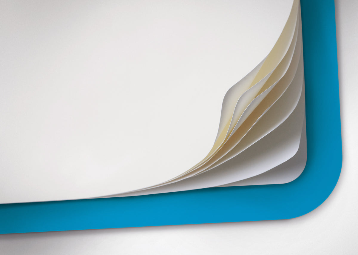Flipping through sheets from a blue notebook on a white background