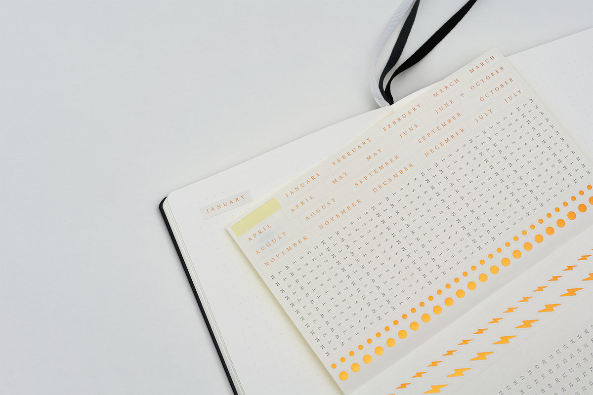 Notebook with grid and dashed line pages on a white background