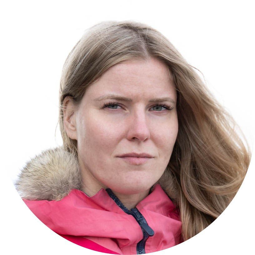 Woman wearing a pink jacket with a fur-lined hood on a white background
