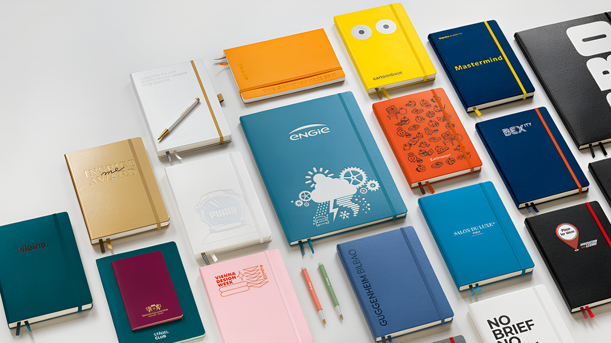 Collection of various notebooks and planners on a white background