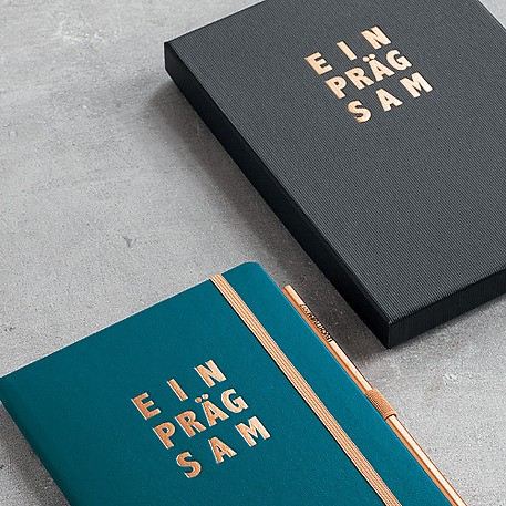 Two notebooks on a gray surface
