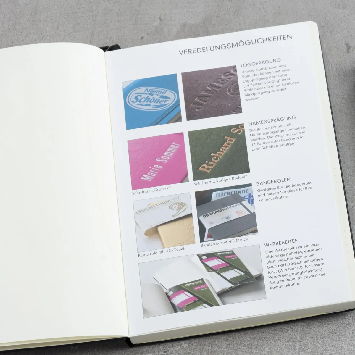 Open book with branded logos on a gray surface