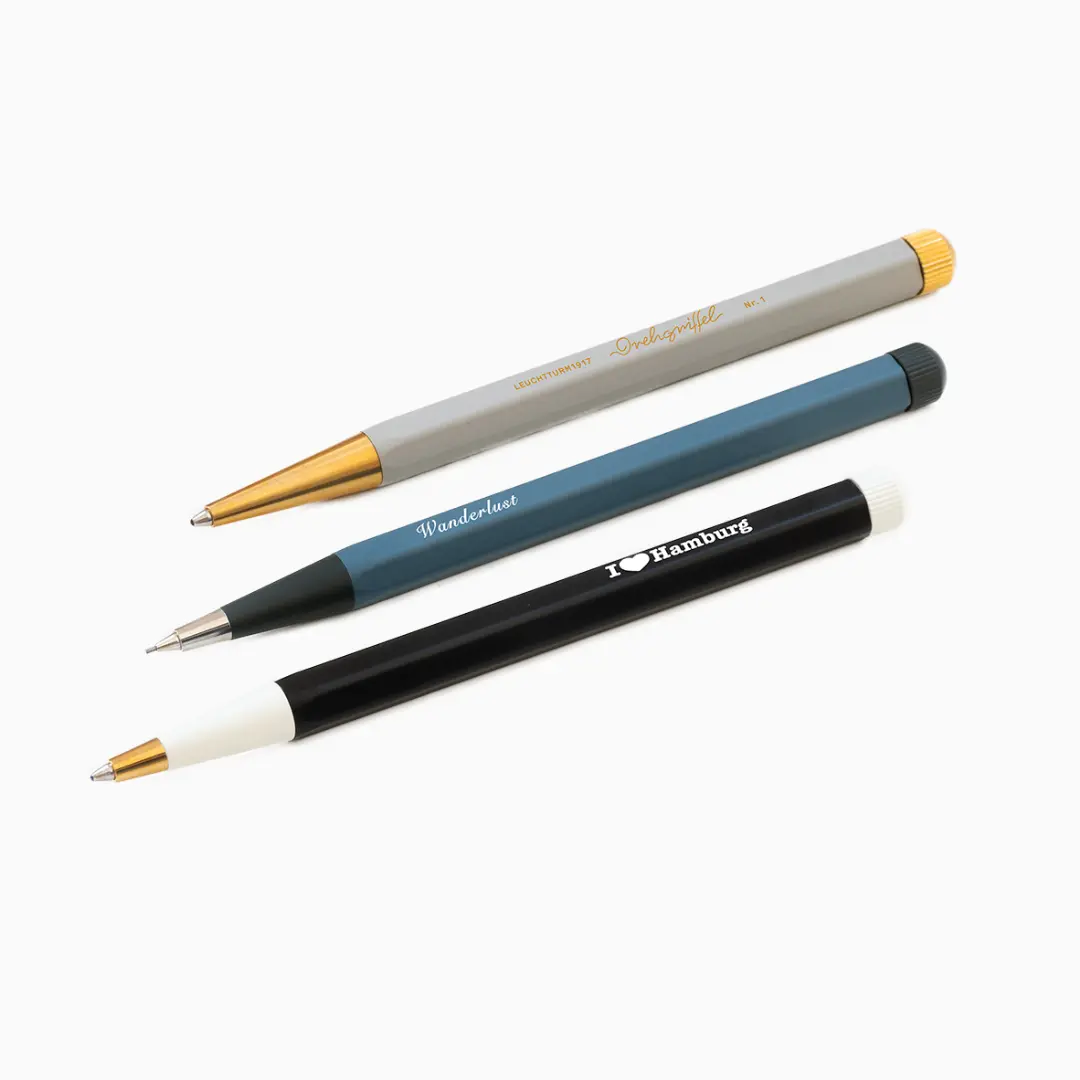 Three pens with different designs and text on a white background