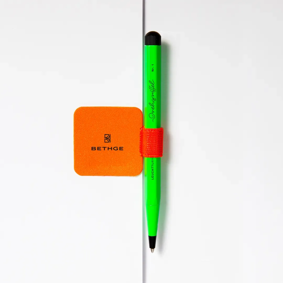 Green pen with red pen loop on a white background