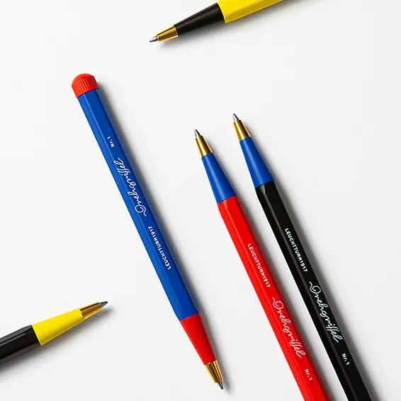 Colorful pens with blue, red, and black bodies on a white background