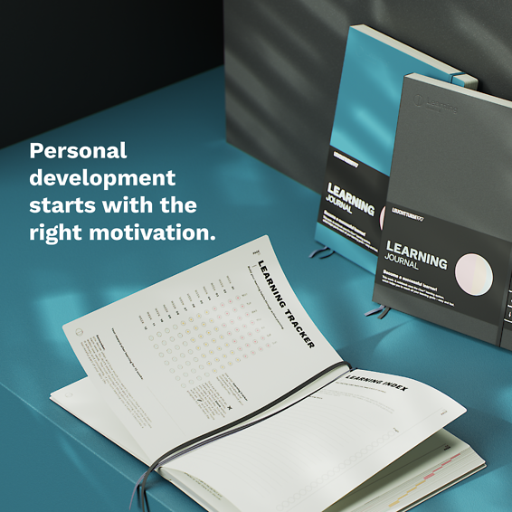 Learning journals on a blue surface with text 'Personal development starts with the right motivation.'