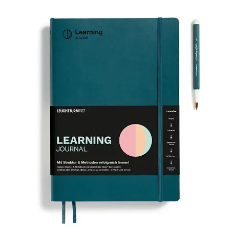 Teal learning journal with a pen on a white background