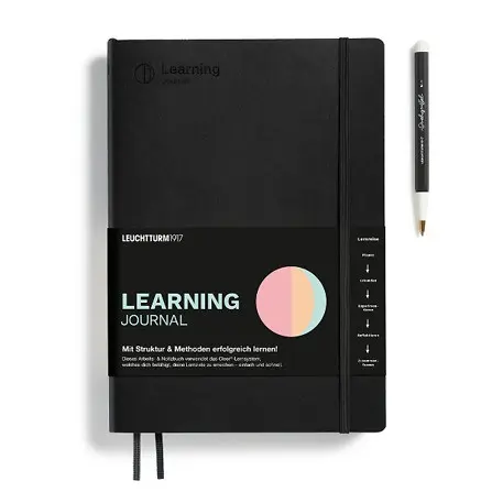 Black Learning Journal with pen on a white background