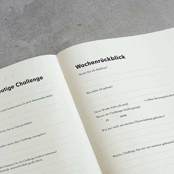 Open notebook with text on a gray surface