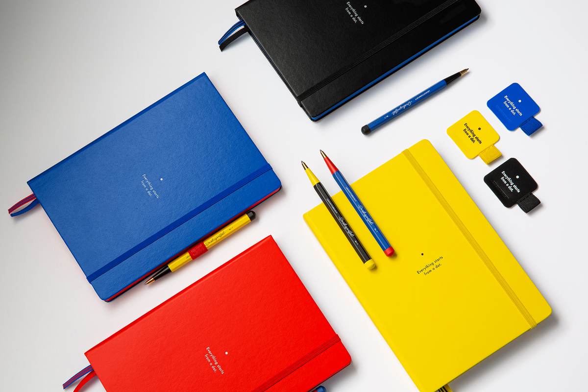 Colorful notebooks and stationery items on a white background