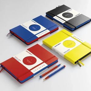 Four colorful notebooks with pen holders on a white background