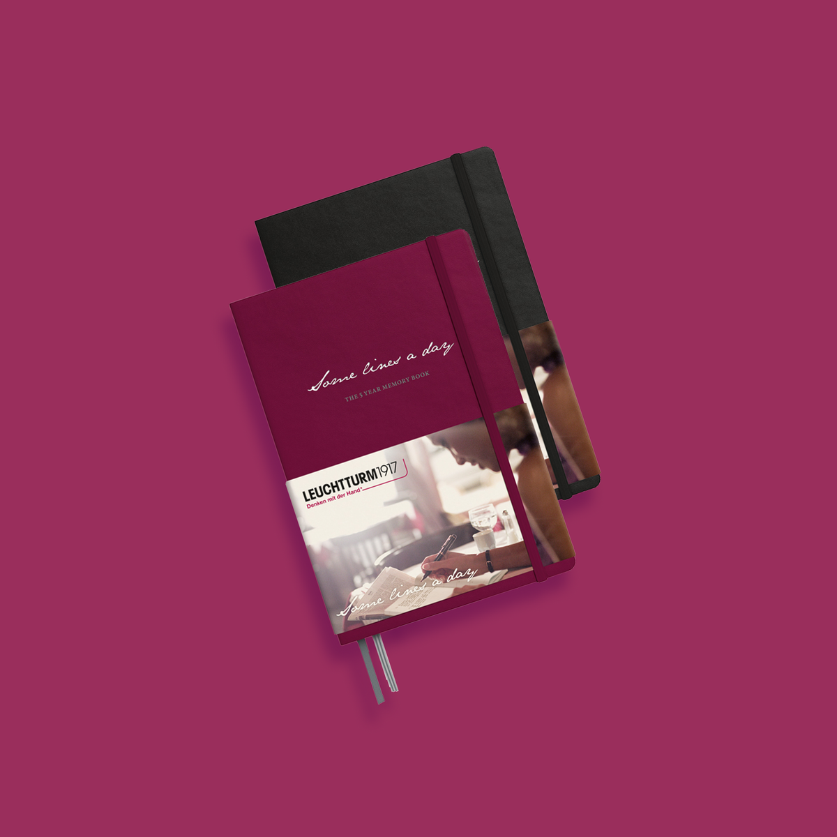 Two notebooks, one red and one black, on a pink background with 'Leuchturm' branding.
