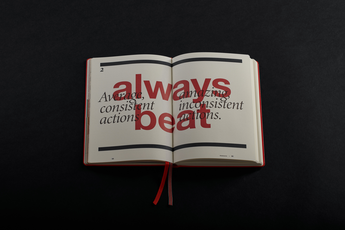 Open book with motivational text on a black background