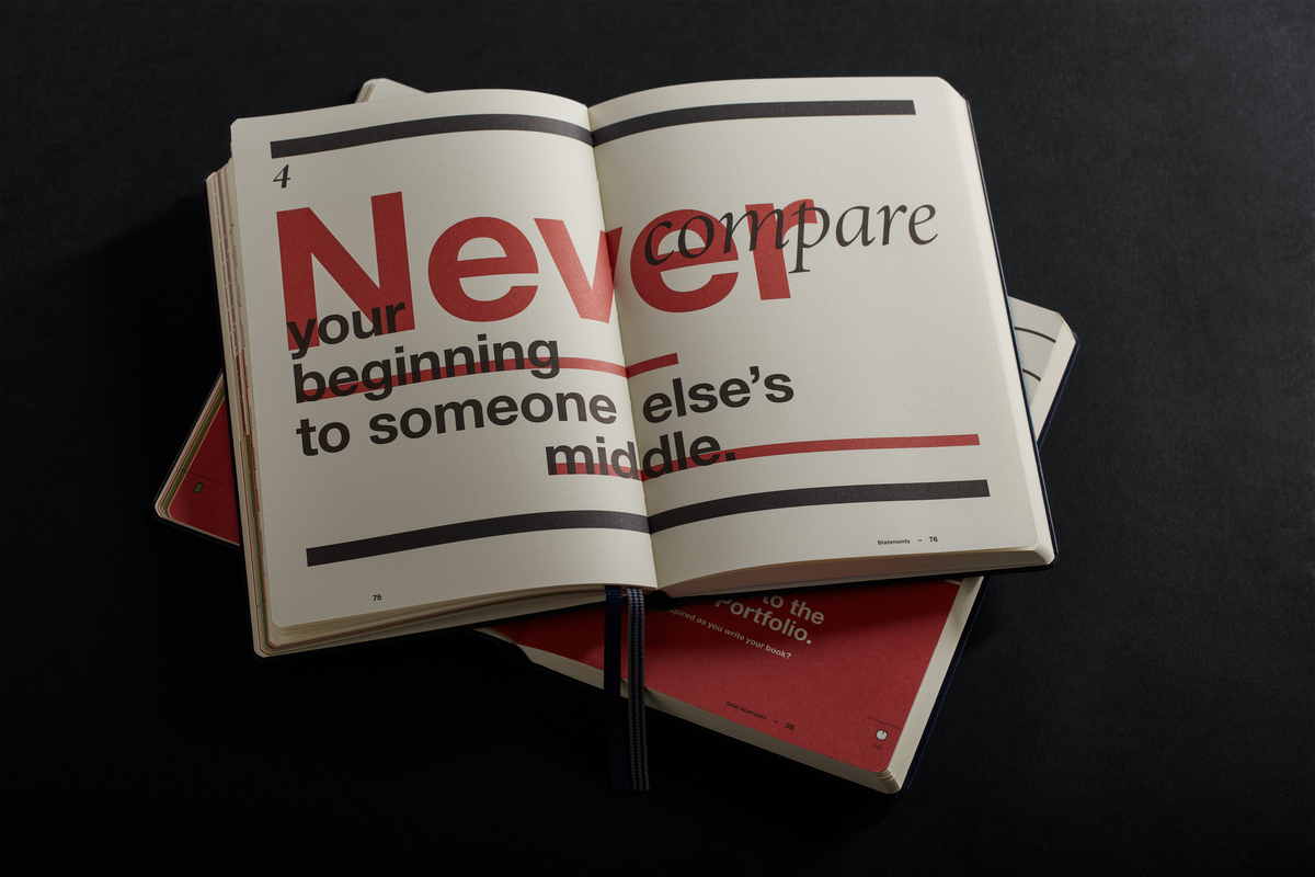 Open book with motivational quote on a black background