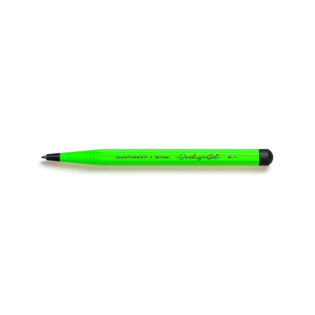Green pen with black cap on a white background