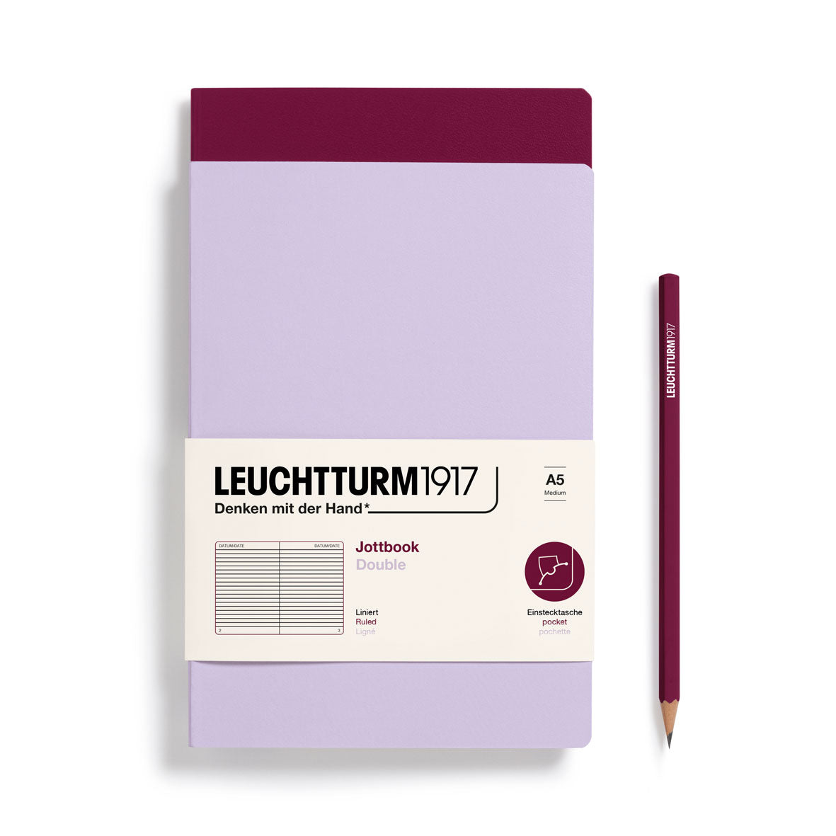 Leuchtturm1917 notebook with a purple cover and pencil on a white background