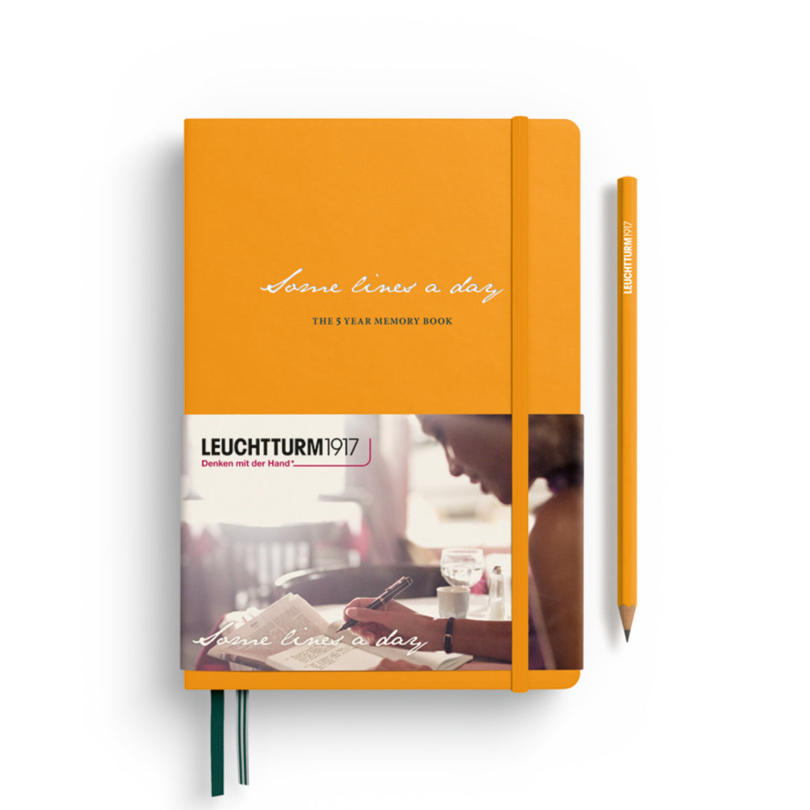 Orange notebook with a pen on a white background