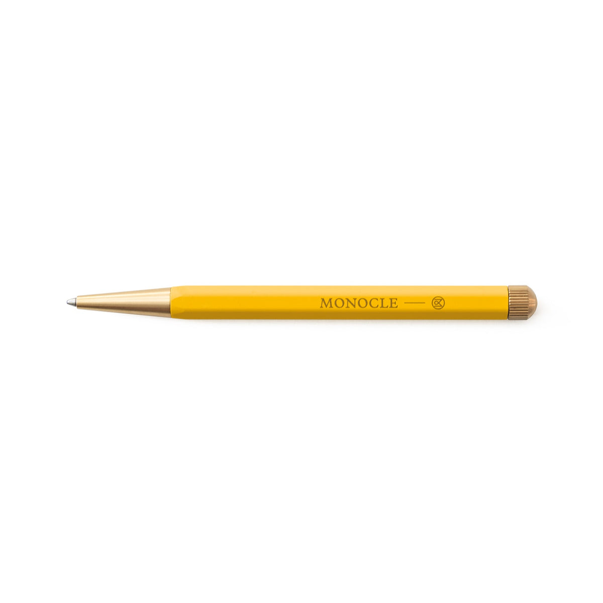 Yellow pen with gold accents on a white background, featuring the Monocle logo.