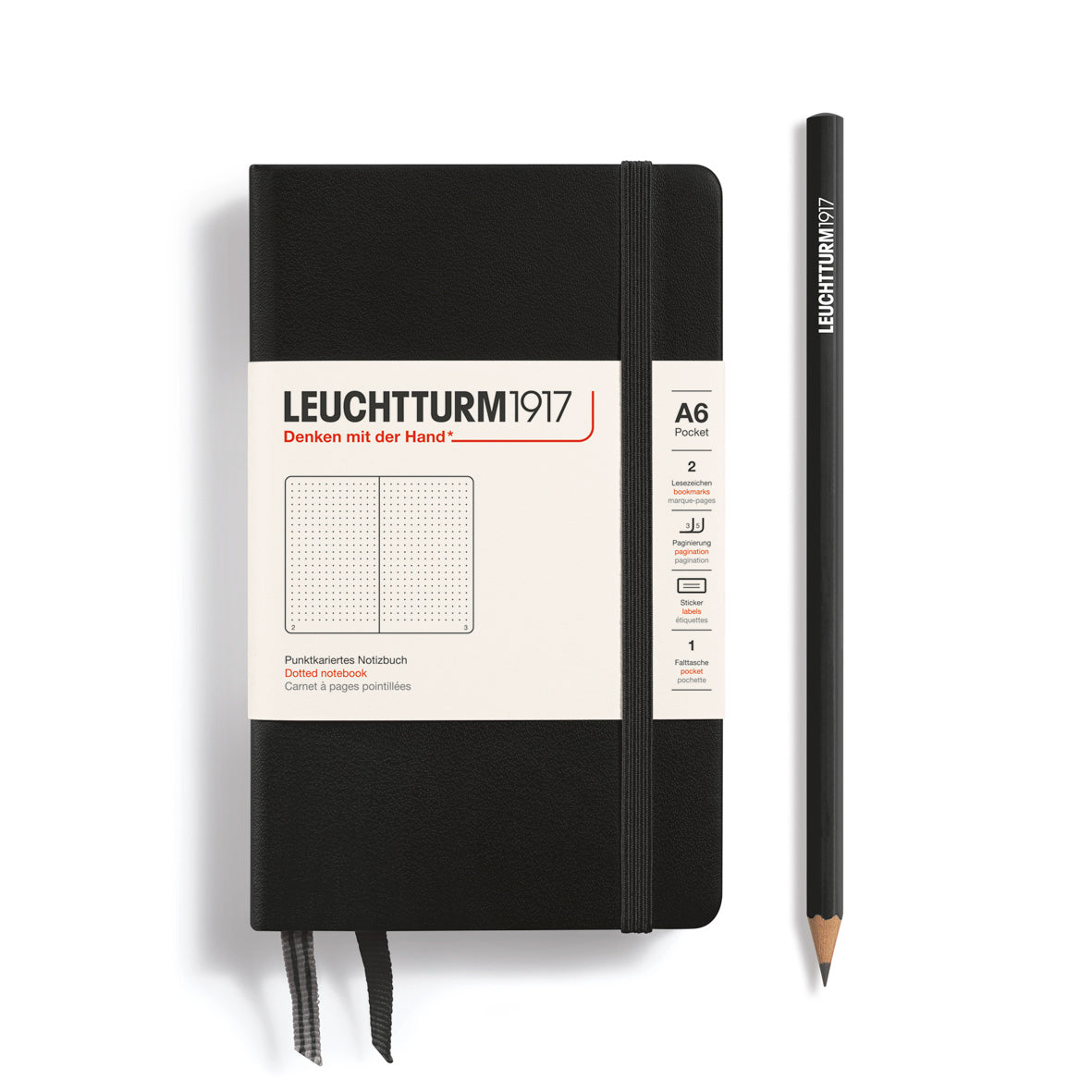 Black notebook with white label and matching pencil on a white background