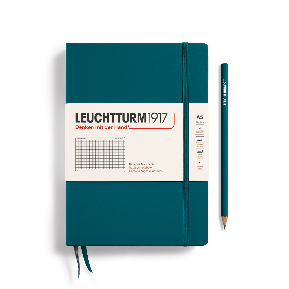 Teal notebook with Leuchtturm1917 branding and a pencil on a white background