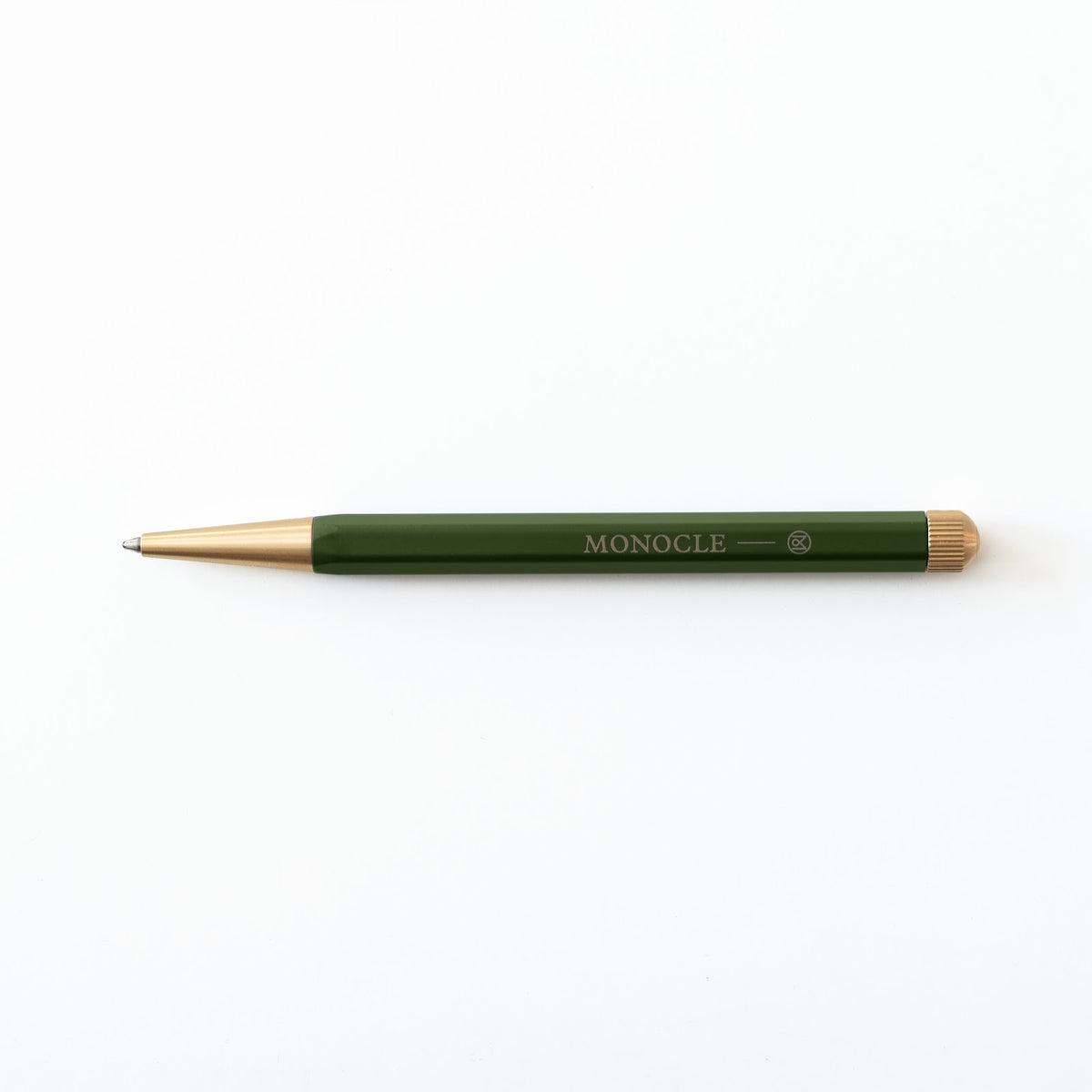 Green pen with gold accents on a white background