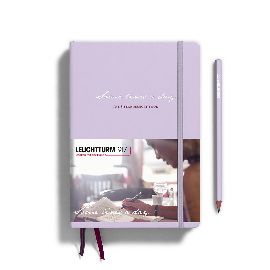 Purple notebook with a pencil on a white background