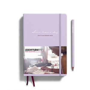 Purple notebook with a pencil on a white background