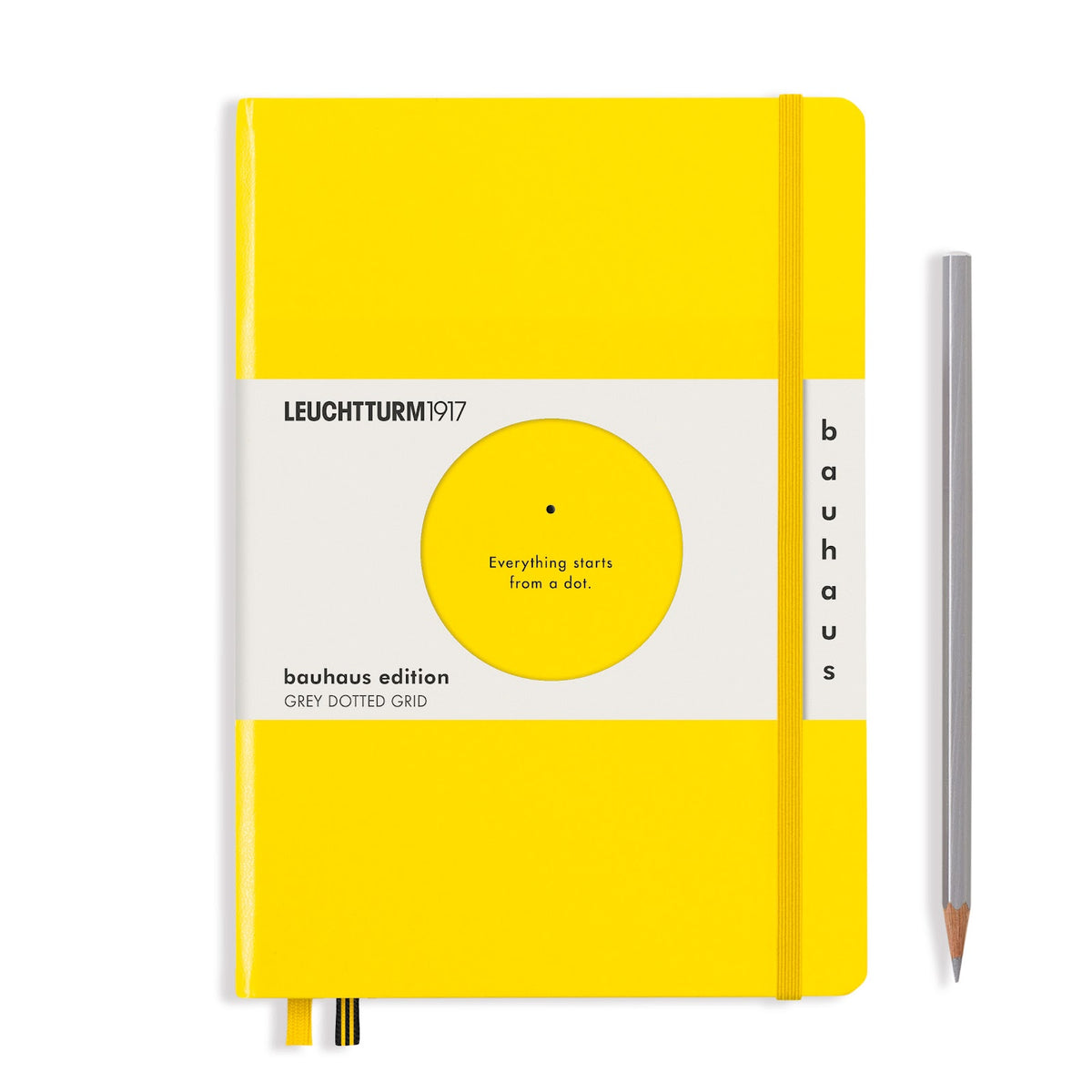 Yellow notebook with Bauhaus edition label and a pencil on a white background