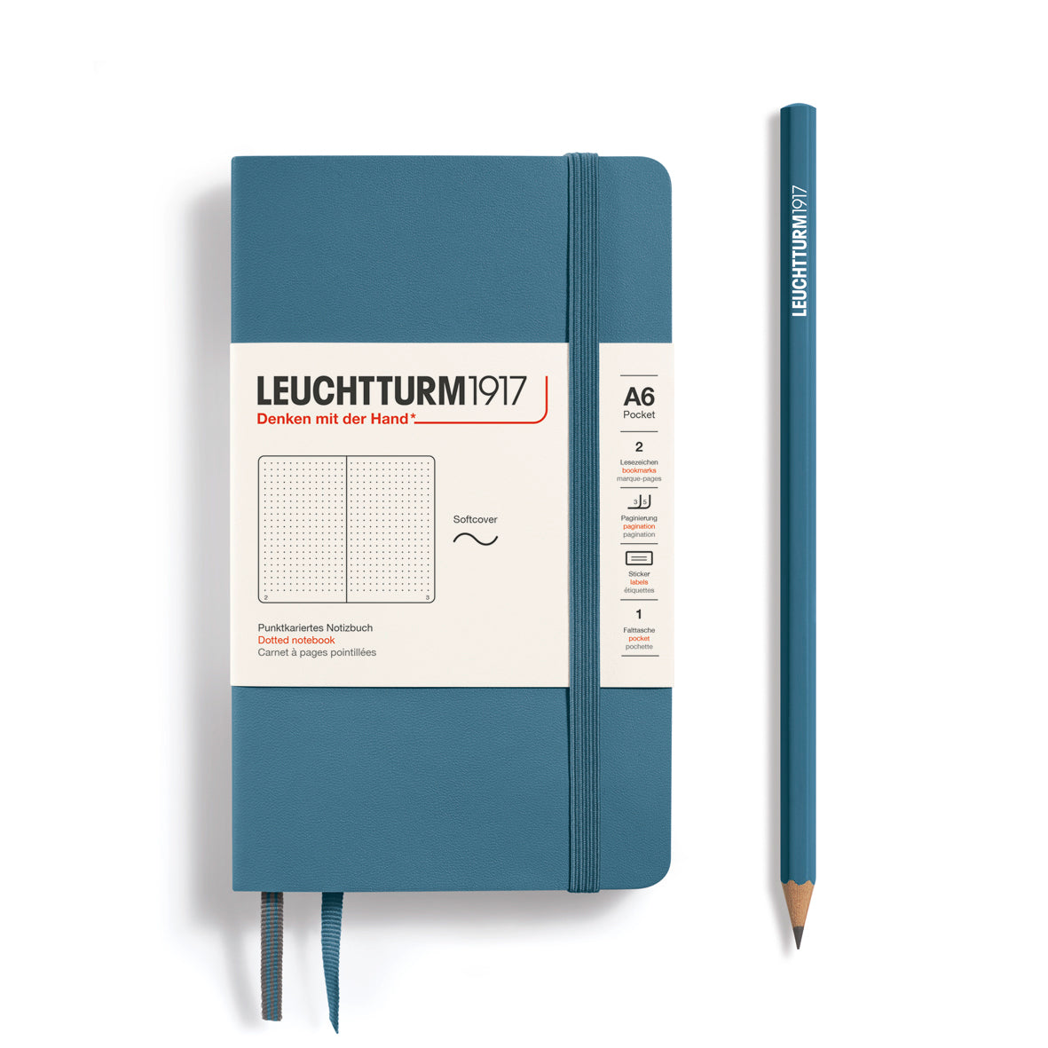 Blue notebook with white label and matching pencil on a white background