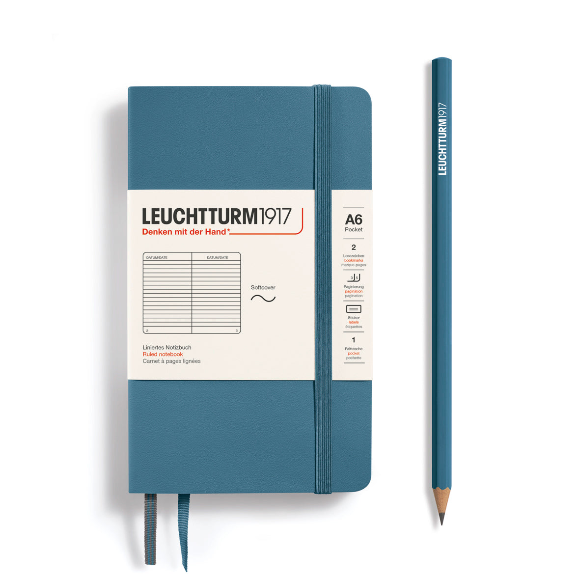 Blue notebook with white label and matching pencil on a white background