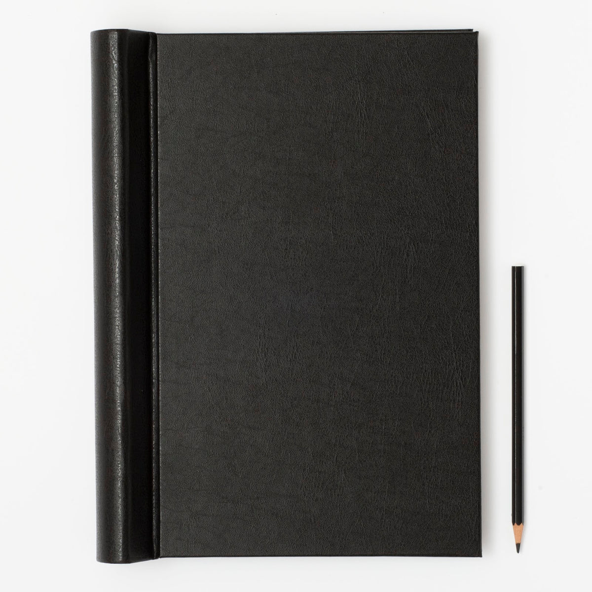 Black notebook with a pencil on a white background