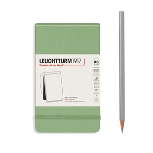 Green notebook with Leuchtturm1917 branding and a pencil on a white background