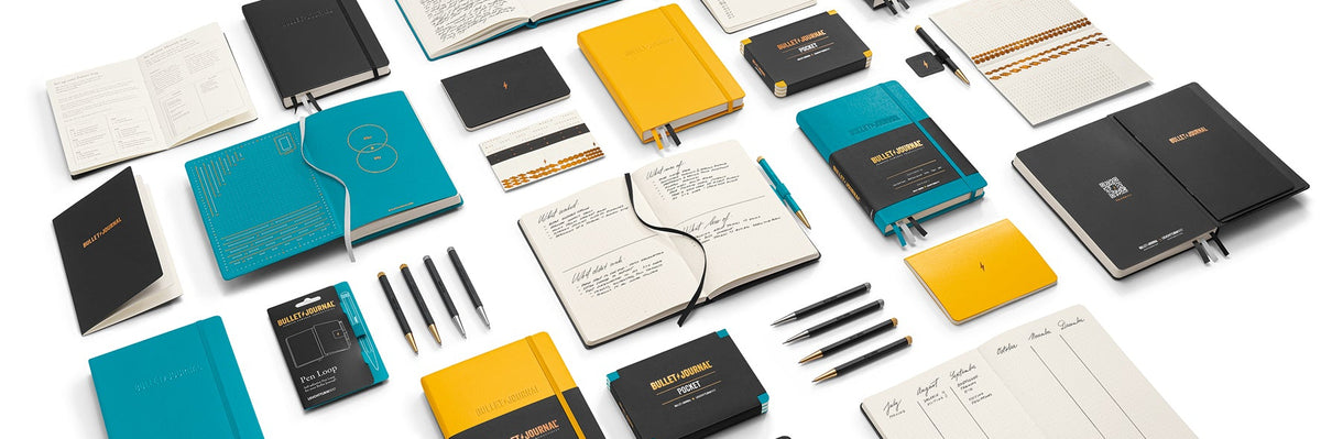 Collection of various notebooks and planners on a white background