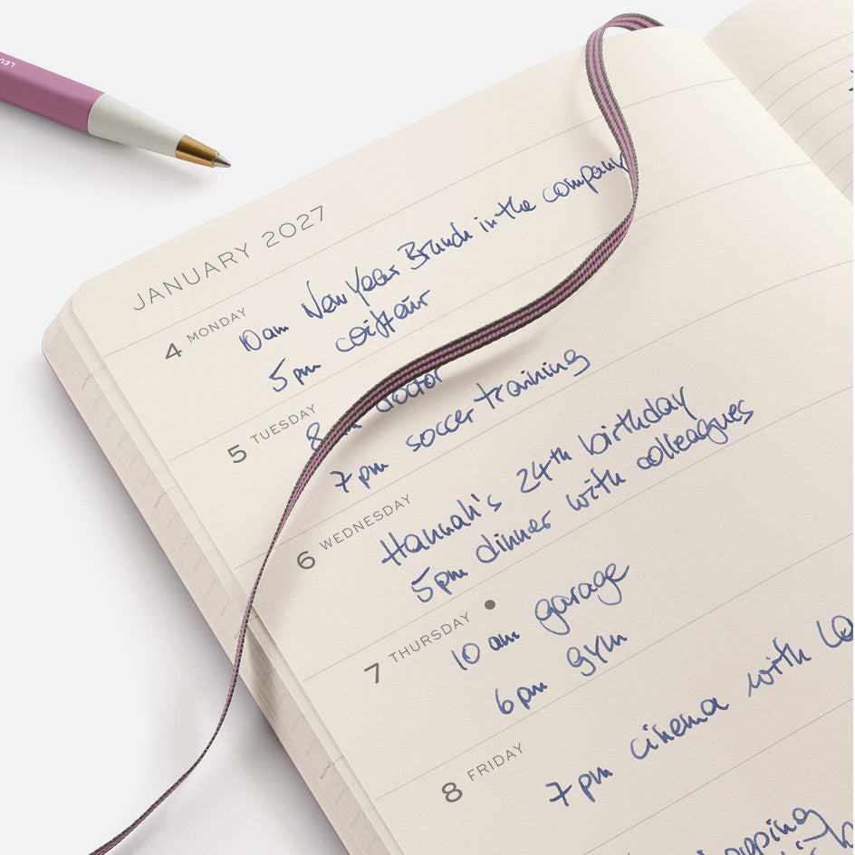 Journal with handwritten January 2023 schedule on a white background
