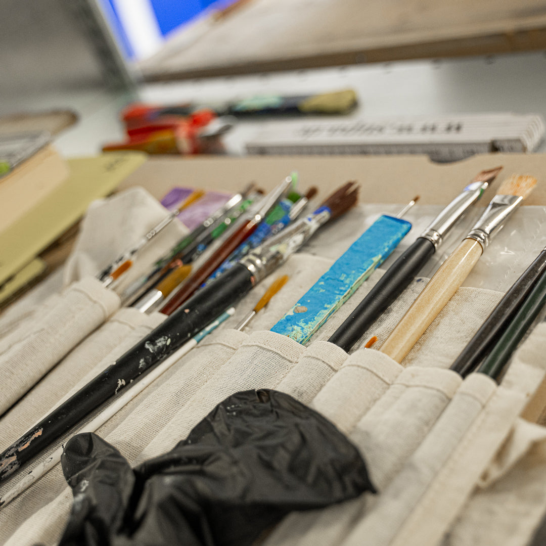 Set of paintbrushes in a holder with a blurred background
