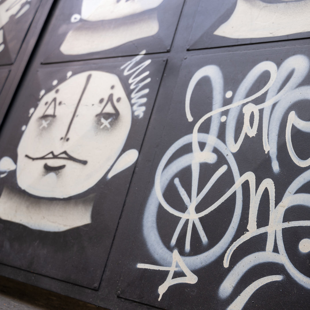 Graffiti art on a wall with abstract designs and text.