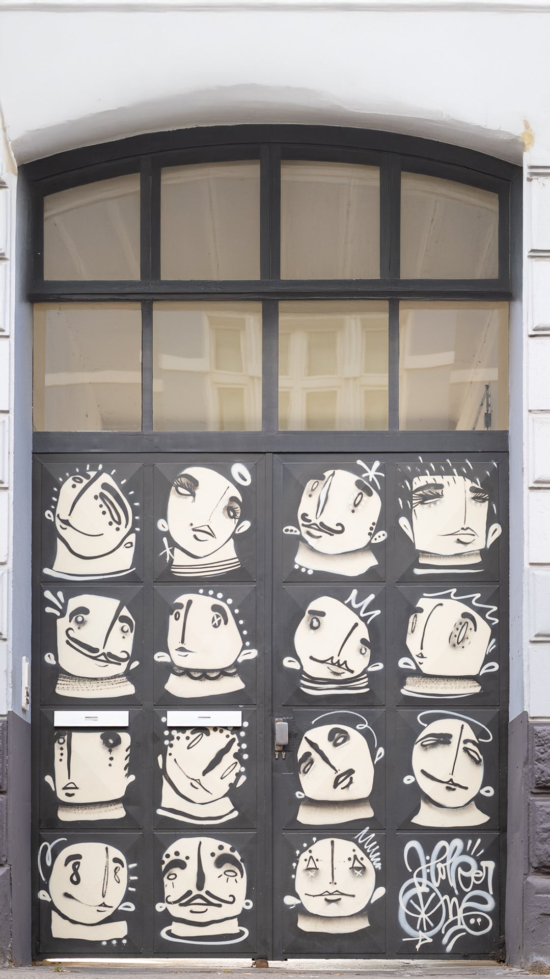 Decorative door with black and white face designs