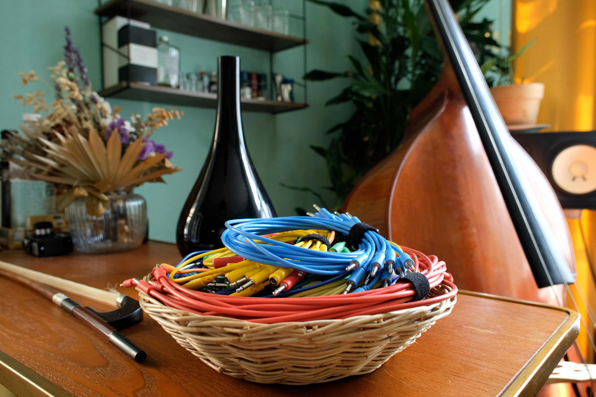 Basket of colorful wires on a wooden table with a blurred background