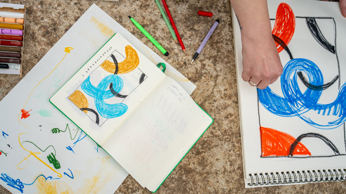 Colorful drawings on paper with markers on a textured surface